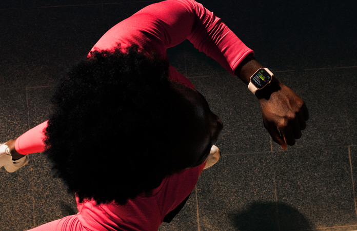 A person checks progress on Apple Watch Series 11 Workout app while running