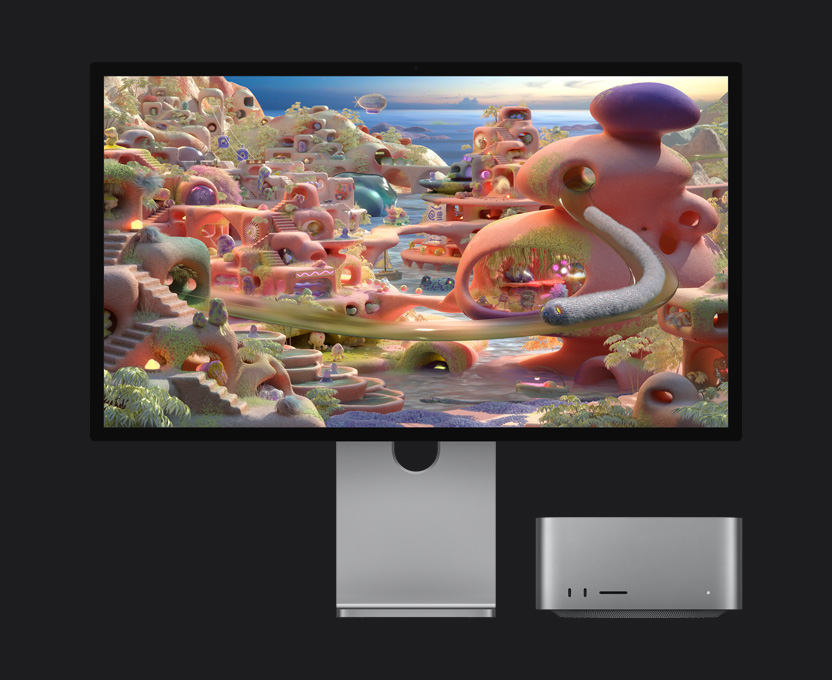 Dans un paysage de dessin animé s’affichant sur un Studio Display XDR avec un Mac Studio glissé en dessous, une créature ressemblant à un ver sort d’un tunnel et se déplace sur l’écran
